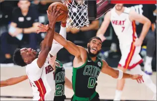  ?? Associated Press photo ?? Miami Heat’s Bam Adebayo, left, battles Boston Celtics’ Jayson Tatum for a rebound during the first half of an NBA conference final playoff basketball game Friday in Lake Buena Vista, Fla.