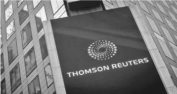  ??  ?? The Thomson Reuters logo is seen on the company building in Times Square, New York. US private equity firm Blackstone Group LP is in advanced talks to buy an approximat­e 55 per cent stake in the Financial and Risk business of Thomson Reuters Corp , a...