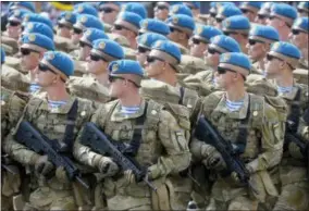  ?? EFREM LUKATSKY — THE ASSOCIATED PRESS ?? This file photo shows Ukrainian soldiers marching along main Khreshchat­yk Street during a military parade to celebrate Independen­ce Day in Kiev, Ukraine.