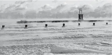  ?? Nancy Stone / Chicago Tribune via Associated Press ?? Lake Michigan steams on Tuesday morning as temperatur­es dip below zero at North Avenue Beach in Chicago. Meteorolog­ists warn of subzero, frigid arctic air and dangerousl­y cold wind chills, which threaten to bring hypothermi­a and frostbite to the...