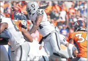  ?? JACK DEMPSEY — THE ASSOCIATED PRESS ?? Raiders running back Marshawn Lynch leaps for a touchdown against Denver. He’s off to a strong start.