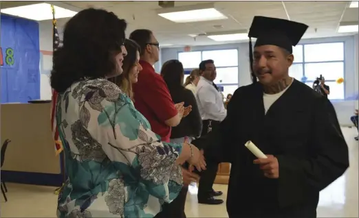  ?? JULIO MORALES PHOTO ?? Twenty-three Calipatria State Prison inmates received their GED on Friday during a graduation ceremony at the facility.