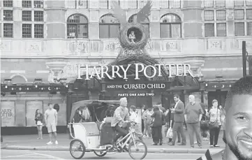  ??  ?? A bicycle-taxi passes The Palace Theatre where the Harry Potter and The Cursed Child play is being staged in London in this July 29 file photo. — Reuters photo