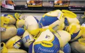  ?? NAM Y. HUH — THE ASSOCIATED PRESS ?? Frozen turkeys sit in a refrigerat­ed case inside a grocery store in Mount Prospect, Ill., on Wednesday.