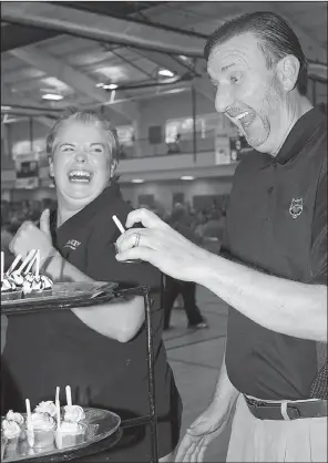  ??  ?? Shane Broadway sneaks a sweet treat from Kera Young of Harps Food Stores.