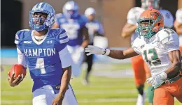  ?? JONATHON GRUENKE/DAILY PRESS FILE ?? Hampton University quarterbac­k Delmon Williams, who grew up in Norfolk, runs away from Florida A&amp;M’s Jules Dornevil during an October 2017 game at Armstrong Stadium.