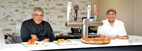  ?? JOHN LIVIERO PHOTOS ?? Frank Donato (right) and his father John are ready for business at the new Franco’s Restaurant location at 1459 Tecumseh Rd. E., close to the original Franco’s which caught fire one year ago today, Dec. 7, 2018.