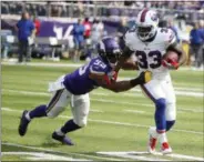  ?? BRUCE KLUCKHOHN - THE ASSOCIATED PRESS ?? In this Sept. 23, 2018, photo, Buffalo Bills running back Chris Ivory (33) runs from Minnesota Vikings defensive end Danielle Hunter (99) during the first half of an NFL football game, in Minneapoli­s. Fans are breathing easier in New Jersey and Seattle, and taking in some rarefied air in Western New York. That’s what happens when your hapless, helpless and hopeless football teams suddenly turn nasty, effective and victorious.