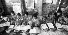  ?? PHOTO: REUTERS, PTI ?? ( Above) A file photo of people outside an NRC office in Assam; Rohingya refugee children at a makeshift school at a refugee camp in Bangladesh’s Cox’s Bazaar. Despite internatio­nal aid, Bangladesh is straining to pay for the upkeep of Rohingya refugees and it fears the problems in Assam will lead to another Rohingya-like crisis along its border with India