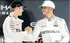  ?? Picture: REUTERS ?? IN A FIRM GRIP: Mercedes’ Formula One drivers Nico Rosberg, left, and Lewis Hamilton shake hands after Rosberg clinched the title