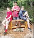  ?? COURTESY PHOTO ?? Colby Mobley, left, Trenton Sisco and Noah Love, students in EAST at Lynch Middle School this past year, built and installed a new bench for Devil’s Den State Park. The bench’s oak top was once a fireplace mantel that had warped. The legs are made of...