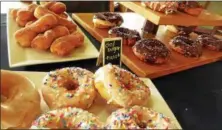  ?? JANET PODOLAK — THE NEWS-HERALD ?? More than a dozen types of freshly made donuts are available to eat in or take out during weekend brunch hours at Sol’s new Donut Bar.