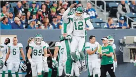  ?? JOHN WOODS THE CANADIAN PRESS ?? Brett Lauther (12) and quarterbac­k David Watford celebrate Saskatchew­an’s 32-27 win.