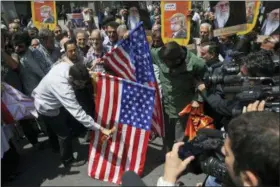  ?? VAHID SALEMI — THE ASSOCIATED PRESS ?? Iranian protestors burn the U.S. flags during a gathering after their Friday prayer in Tehran, Iran, Friday. Thousands of Iranians took to the streets in cities across the country to protest U.S. President Donald Trump’s decision to pull out of the...