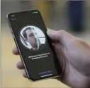  ?? THE ASSOCIATED PRESS FILE PHOTO ?? An Apple employee demonstrat­es the facial recognitio­n feature of the new iPhone X.