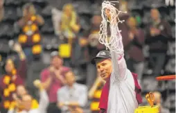  ?? MIKE STEWART/ AP ?? Loyola head coach Porter Moser holds the net after a regional final NCAA tournament win against Kansas State, March 24, in Atlanta.