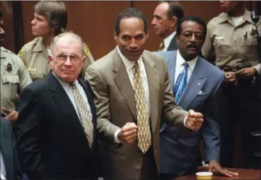  ?? DAILY NEWS — THE ASSOCIATED PRESS FILE ?? O.J. Simpson reacts as he is found not guilty of murdering his ex-wife Nicole Brown Simpson and her friend Ron Goldman, at the Criminal Courts Building in Los Angeles. At left is defense lawyer F. Lee Bailey and at right is defense attorney Johnnie...