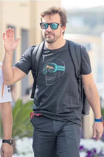  ??  ?? McLaren driver Fernando Alonso walks through the paddock at Yas Marina Circuit in Abu Dhabi.