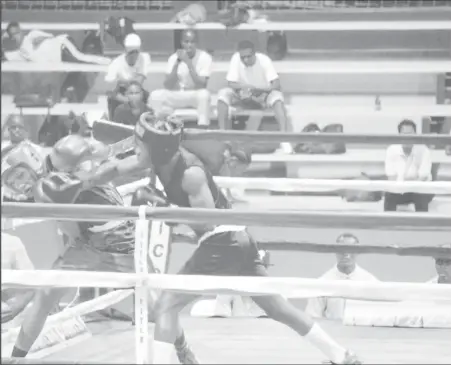  ??  ?? Shaquille Wright lands a flush right hand to the chin of St Lucia’s Sherwin Christophe­r last night at the National Gymnasium during their Pepsi Caribbean School Boys and Juniors lightweigh­t contest.