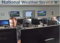  ?? MARK HOFFMAN / MILWAUKEE JOURNAL SENTINEL ?? Warning coordinati­on meteorolog­ist Tim Halbach (left) works at the National Weather office in Sullivan. At right is lead forecaster Mark Gehring.