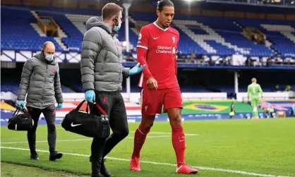  ??  ?? The injured Virgil van Dijk leaves Goodison Park. Photograph: Laurence Griffiths/PA