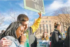  ??  ?? Great Mills High School junior Dylan Hill, 16, consoles sophomore Zahreya Peeples, 16, who weeps during Saturday’s march in Washington.