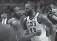  ?? The Associated Press ?? GOOD GAME: Cleveland Cavaliers forward LeBron James (23) greets Washington Wizards guard John Wall (2) after Sunday’s game in Washington. The Cavaliers edged Washington 106-99.
