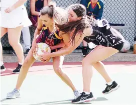  ??  ?? Above: Thorpdale centre Bianca Fahey has eyes for the ball in C grade against Tarwin on Saturday.
Right: Both getting hands to the ball on the goal circle during the B grade clash are Warragul Industrial­s’ wing attack Abby Brice and Dalyston wing defence Abbey Kirk.