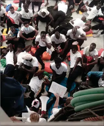  ??  ?? „ The migrants crowd the deck of the rescue ship Aquarius now stuck in the middle of the Mediterran­ean Sea.