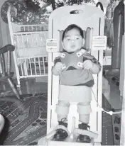  ?? Courtesy of the Nguyen Family ?? A therapeuti­c device called a stander gave a young Justin Nguyen the sensation of standing.