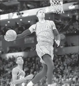  ?? Chuck Burton Associated Press ?? THE LAKERS’ Kyle Kuzma dunks during the Rising Stars game in Charlotte. He scored a game-high 35 points to help Team USA defeat Team World 161-144.