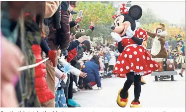  ?? — China Daily/Asia News Network ?? Buy the ticket, take the ride: Disney cartoon characters interactin­g with visitors at Shanghai Disneyland.