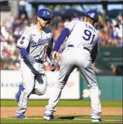  ?? Tony Avelar Associated Press ?? AUSTIN BARNES passes third base coach Dino Ebel after hitting a fifth-inning home run Saturday.