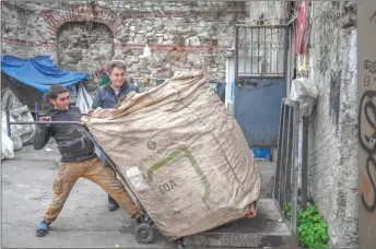  ?? ?? Afghan refugees collect waste at a dumping ground in Istanbul.