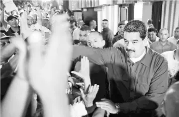  ??  ?? Maduro greets supporters during a meeting in Caracas. — Reuters photo