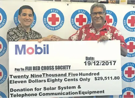  ?? Photo: Nacanieli Tuilevuka ?? Fiji Red Cross Director General Filipe Nainoca (right), receiving a cheque of $29,511.80 from Exxon Mobil Country Manager Patrick Bulaon at the society’s boardroom in Suva on January 18, 2018.