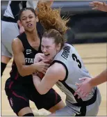  ?? DAVID ZALUBOWSKI — THE ASSOCIATED PRESS ?? Colorado guard Frida Formann, front, pulls in a rebouind as Stanford guard Anna Wilson defends in overtime on Sunday in Boulder, Colo.