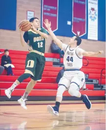  ?? ROBERTO E. ROSALES/JOURNAL ?? West Las Vegas guard D.J. Bustos, left, jumps to grab a pass as Silver’s Wyatt Oglesby defends during their game Thursday.