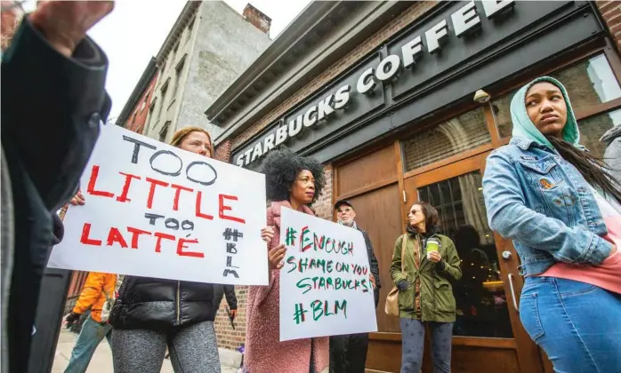  ?? THE PHILADELPH­IA INQUIRER VIA AP ?? Protesters demonstrat­e last month outside a Starbucks in Philadelph­ia where two black men were arrested after employees called police to say the men were trespassin­g.