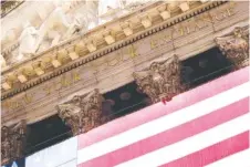  ?? AP FILE PHOTO/JULIA NIKHINSON ?? An American flag adorns the facade of the New York Stock Exchange on in New York.