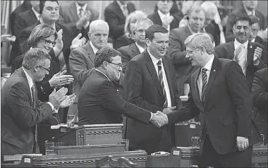  ?? CHRIS WATTIE
REUTERS ?? Prime Minister Stephen Harper congratula­tes Jim Flaherty after he delivered his budget on Thursday.