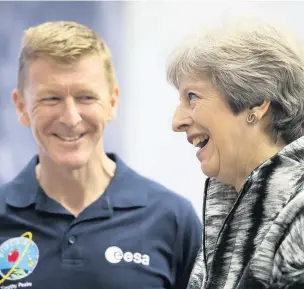  ??  ?? > Theresa May with astronaut Tim Peake at Farnboroug­h Airshow on Monday