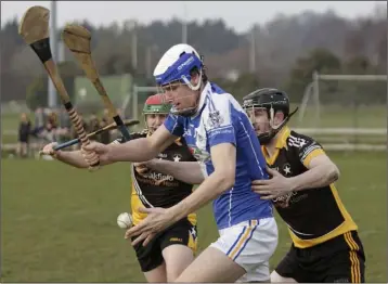  ??  ?? Ballygarre­tt defenders Philip Doyle and Darren Morris apply pressure on Eire Og’s Michael Walsh.