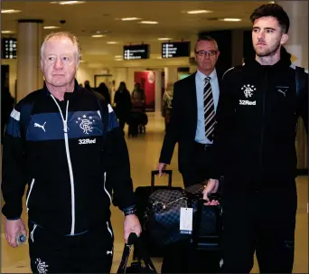  ??  ?? Jimmy Nicholl and Sean Goss arrive at Glasgow Airport yesterday for Rangers’ winter trip to Orlando