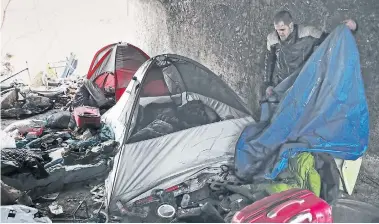  ?? RENÉ JOHNSTON TORONTO STAR ?? Frenchie Simard collects some belongings before the city took down several homeless camps in the Rosedale Valley ravine. He says shelters aren’t an option. “Bed bugs. Violence. Stealing. I won’t live in that kind of place. I prefer my bridge.”