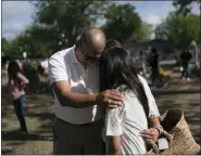  ?? AP PHOTO/JAE C. HONG ?? Ernest Oviedo, left, prays with wife, Lori, and their daughter, Vivianna, at a memorial at Robb Elementary School in Uvalde, Texas, on Thursday.