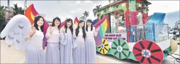  ??  ?? Five lovely ‘angels’ with their cheerful warm smile next to a colourful float.