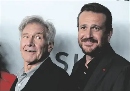  ?? AP PHOTO/CHRIS PIZZELLO ?? Harrison Ford (left) a cast member in “Shrinking,” looks over at fellow cast member Jason Segel at the premiere of the Apple TV+ series, on Thursday at the Directors Guild of America in Los Angeles.