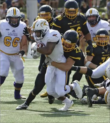  ?? IAN STEWART, SPECIAL TO THE RECORD ?? Laurier Golden Hawks running back Levondre Gordon gets pulled down by Waterloo’s Sammy Prantera during the second quarter.
