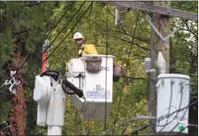  ?? H John Voorhees III / Hearst Connecticu­t Media ?? Crews work on downed power lines in Bethel last year after a storm moved through the area.